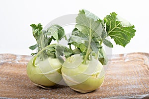Three pieces of kohlrabi vegetable isolated on yellow simple background with copy space
