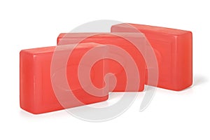 Three pieces of red toilet soap on a white background. Full depth of field.