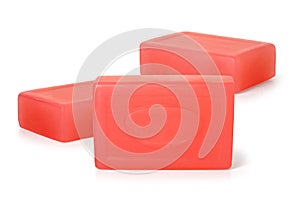 Three pieces of red toilet soap on a white background. Full depth of field.