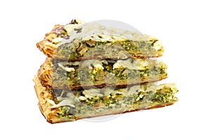 Three pieces of traditional greek spinach pie with goat cheese