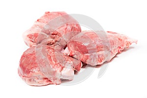 Three pig cheeks raw pieces in a white background