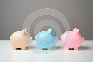 Three piggy banks lined up in a chain. Savings management.