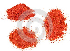 Three piles of ground red chili pepper - paprika