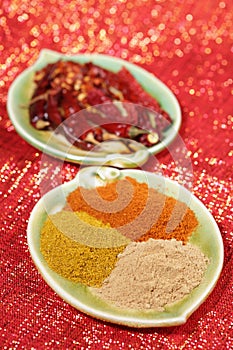 Three piles of indian powder spice on plate
