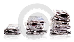 Three piles of newspaper