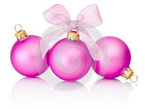 Three pink christmas balls with ribbon bow Isolated on white