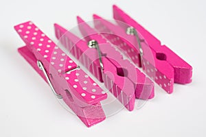 Three Pink Clothes Pins with Fun Patterns Two on Sides Perspective View