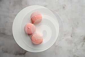 Three pink macarons ly flat lay photo