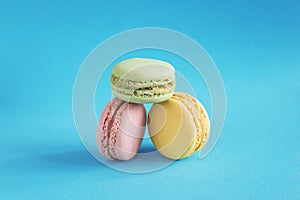 Three pink, yellow and green french macaroons