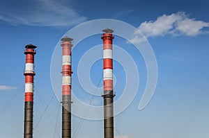 Three pipes of plant against background of blue sky/pipes of the plant against the background of the sky