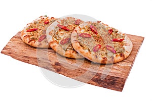 Three Pizza with curry sauce, meat, red pepper on a wooden background. The object is isolated on a white background