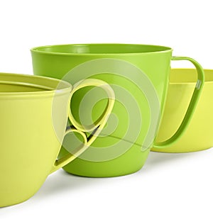 Three plastic mugs yellow and green