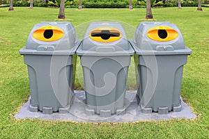 Three plastic recycle bins to separate different waste products