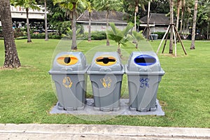 Three plastic recycle bins to separate different waste products