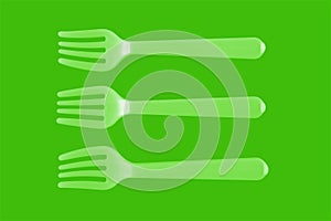 three plastic white forks on a green background. isolate. Top view.