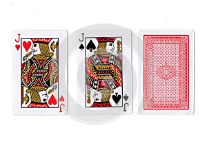 Three playing cards with a pair of jacks revealed.