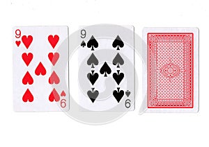 Three playing cards with a pair of nines revealed. photo