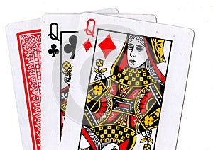 Three playing cards with a pair of queens revealed.