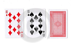 Three playing cards with a pair of tens revealed.