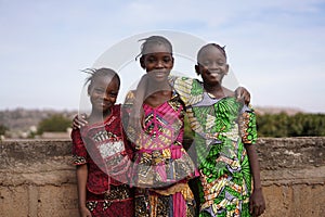 Three Pleasant African Girls Posing For A Panorama Picture On a Bridge