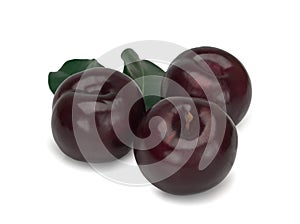 Three plums with leaves on white background
