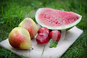 Three plums with pears and watermelon