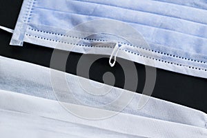 Three ply structure,single use hygenic,surgical,face mask with deformable wire isolated on black background.