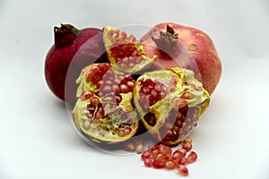 Pomegranates and grains on white background