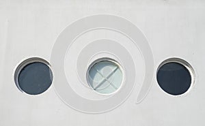 Three porthole of white sailing ship