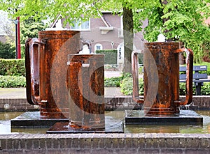 The three pots of Olen. Sculpture of copper pots. Pot fontain in Olen, province of Antwerp, Belgium.