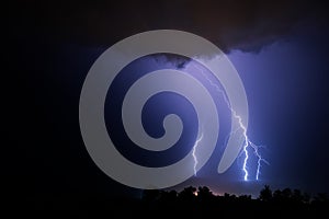 Three powerful lightning bolts during a night thunderstorm