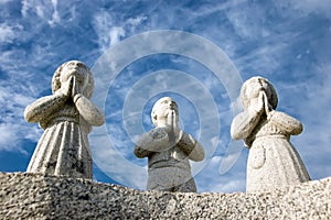 Three praying statues