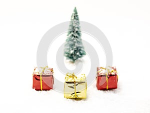 Three presents, two red and one yellow with ribbons