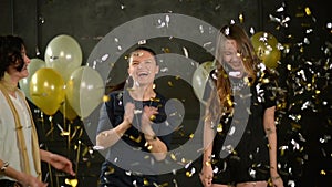 Three Pretty Women Having Fun Together During a Disco Party. Beautiful Crazy Girls are Dancing among Golden and Silver