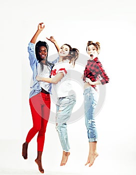 Three pretty young diverse nations teenage girl friends jumping happy smiling on white background, lifestyle people