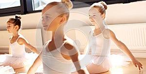 Three pretty young girls in ballet class