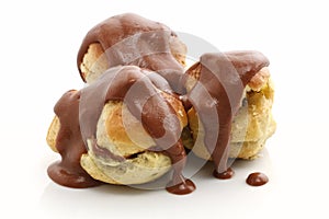 Three profiteroles over white