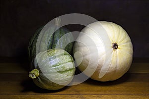 Three pumpkins on wood table