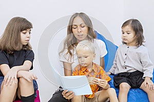 Three pupils calmly observing the storytelling