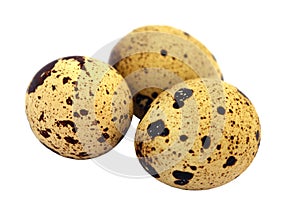 Three quail eggs on a white background isolated