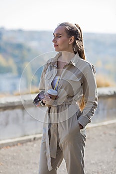 Three quarter length portrait of blonde person in a jumpsuit in public Park