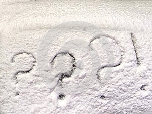 Three question and exclamation marks written in the snow. The cold frosty texture of the snow and the question mark