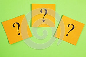 Three Question Marks Orange on Green Background