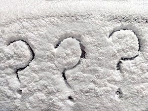 Three question marks written in the snow. The cold frosty texture of the snow and the question mark. Background, place