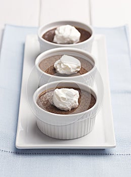 Three Ramekins of Chocolate Pot de Creme or Baked Custard with Whipped Cream photo
