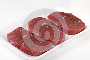 Three raw beef minute steaks