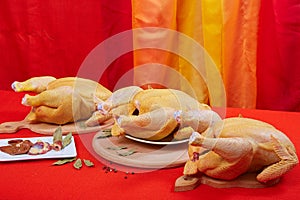 Three raw chicken on red background