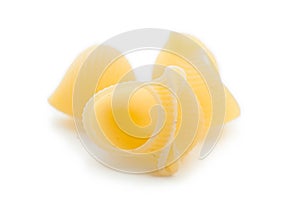 Three of raw macaroni shells, selective focus. Isolated on white