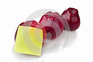 Three red apples with stiker note