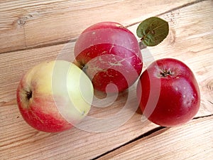 Three red apples on a wooden table apple spas